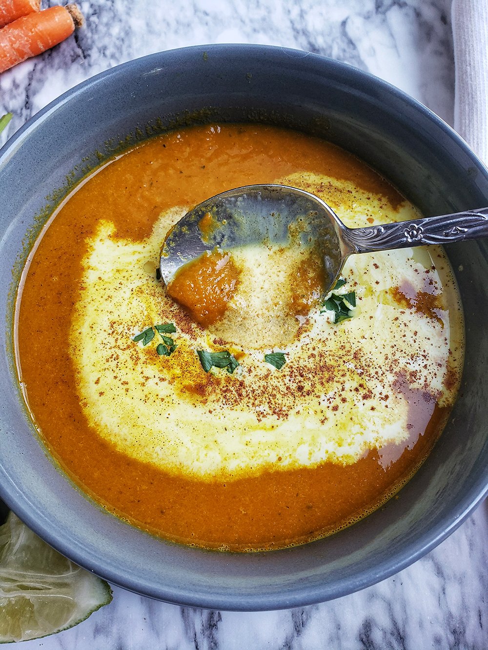 carrot and ginger soup with yogurt on top.