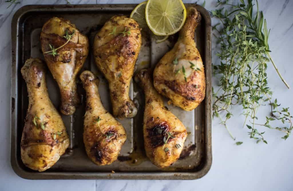 easy oven baked chicken drumsticks on a pan just coming out of the oven
