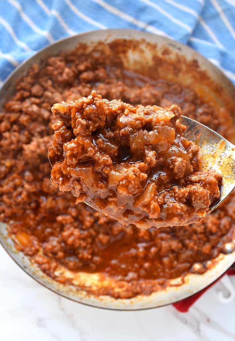 an easy and delicious sloppy joe sauce in a large spoon scooped from a skillet